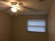 Bright bedroom with ceiling fan and window blinds at 1500 Wildrose Ln, Daytona Beach, FL 32117