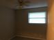 Small bedroom with ceiling fan, window, and light walls at 1500 Wildrose Ln, Daytona Beach, FL 32117