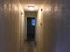 Long hallway with light walls and terrazzo flooring at 1500 Wildrose Ln, Daytona Beach, FL 32117