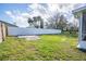 Fenced backyard with a grassy area and shed at 18 Wildwood Dr, Edgewater, FL 32132