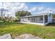 Large backyard with screened porch and grassy area at 18 Wildwood Dr, Edgewater, FL 32132