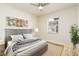 Guest bedroom with gray headboard, wood flooring and window at 18 Wildwood Dr, Edgewater, FL 32132