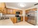 Updated kitchen featuring stainless steel appliances and wood cabinetry at 18 Wildwood Dr, Edgewater, FL 32132