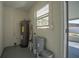 Laundry room with water heater and storage space at 18 Wildwood Dr, Edgewater, FL 32132