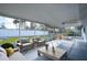 Relaxing screened porch with wooden furniture at 18 Wildwood Dr, Edgewater, FL 32132