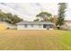 Spacious backyard with grassy area and privacy fence at 1820 Sabal Palm Dr, Edgewater, FL 32132