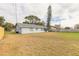 Spacious backyard with grassy area and privacy fence at 1820 Sabal Palm Dr, Edgewater, FL 32132