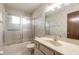 Bathroom with a shower/tub combo, a vanity with sink, and floral wallpaper at 1820 Sabal Palm Dr, Edgewater, FL 32132