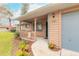 A home's front porch with a wooden railing, an American flag, and some potted plants at 1820 Sabal Palm Dr, Edgewater, FL 32132