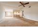 Spacious living room with carpeted floors and a view into the kitchen area at 1820 Sabal Palm Dr, Edgewater, FL 32132