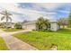 House exterior showcasing a well-maintained lawn and driveway at 1846 Turnbull Lakes Dr, New Smyrna Beach, FL 32168