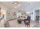 Relaxing living room with hardwood floors, comfortable seating, and large windows at 1846 Turnbull Lakes Dr, New Smyrna Beach, FL 32168