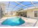 Resort-style pool with screened enclosure and patio furniture at 1846 Turnbull Lakes Dr, New Smyrna Beach, FL 32168