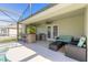 Screened pool patio with outdoor kitchen and seating at 1846 Turnbull Lakes Dr, New Smyrna Beach, FL 32168