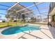 Inviting kidney-shaped pool with screened enclosure at 1846 Turnbull Lakes Dr, New Smyrna Beach, FL 32168