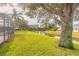 Landscaped backyard with canal view and large tree at 1846 Turnbull Lakes Dr, New Smyrna Beach, FL 32168