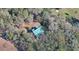 Aerial view of log cabin home nestled amongst the trees at 187 N Samsula Dr, New Smyrna Beach, FL 32168