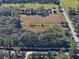 Aerial view of property showing home, road, and fields at 187 N Samsula Dr, New Smyrna Beach, FL 32168