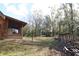 Cabin's backyard with shed and wooded area at 187 N Samsula Dr, New Smyrna Beach, FL 32168