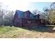 Rustic log cabin with a green metal roof and a spacious porch at 187 N Samsula Dr, New Smyrna Beach, FL 32168