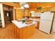 Kitchen with island and ample cabinetry, overlooking the dining area at 187 N Samsula Dr, New Smyrna Beach, FL 32168