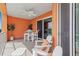 Orange-walled balcony with seating and a table at 2 Riverwalk Dr # 502, New Smyrna Beach, FL 32169