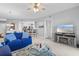 Bright living room with blue couches, fireplace, and balcony access at 2 Riverwalk Dr # 502, New Smyrna Beach, FL 32169