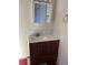 Bathroom vanity with brown cabinets and a white countertop at 202 S Myrtle Ave, New Smyrna Beach, FL 32168