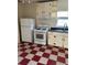 Retro kitchen with white appliances and red checkered floor at 202 S Myrtle Ave, New Smyrna Beach, FL 32168