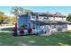 Rear view of house showcasing solar panels and landscaping at 2202 Venetian Ave, Belle Isle, FL 32809