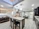 Eat-in kitchen with granite island and modern pendant lighting at 2202 Venetian Ave, Belle Isle, FL 32809