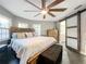 Bright bedroom with sliding barn door to ensuite bathroom at 2202 Venetian Ave, Belle Isle, FL 32809