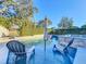 Relaxing pool area with lounge chairs in the water at 2202 Venetian Ave, Belle Isle, FL 32809