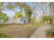 Landscaped backyard with shed and walkway at 2304 Date Palm Dr, Edgewater, FL 32141