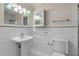 Bathroom with pedestal sink, toilet, and white tile at 2304 Date Palm Dr, Edgewater, FL 32141