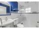 Bathroom with blue vanity, white tile, and glass shower at 2304 Date Palm Dr, Edgewater, FL 32141