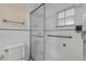 Clean bathroom with shower, grab bars, and white tile at 2304 Date Palm Dr, Edgewater, FL 32141