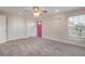 Bedroom with pink door and ceiling fan at 2304 Date Palm Dr, Edgewater, FL 32141