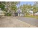 Two-car garage with a bench and palm trees at 2304 Date Palm Dr, Edgewater, FL 32141