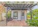 White guest house with pergola, swing, and lush landscaping at 2304 Date Palm Dr, Edgewater, FL 32141