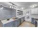 Modern kitchen with gray cabinets, white subway tile, and stainless steel appliances at 2304 Date Palm Dr, Edgewater, FL 32141