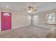 Living room with pink door, neutral walls, and large windows at 2304 Date Palm Dr, Edgewater, FL 32141