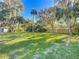 Large backyard with lush lawn and mature trees at 2322 Melonie Trl, New Smyrna Beach, FL 32168