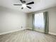 Light-filled bedroom featuring a ceiling fan and tile floors at 2322 Melonie Trl, New Smyrna Beach, FL 32168