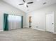 Primary bedroom with ceiling fan, tile floors, and ensuite bathroom access at 2322 Melonie Trl, New Smyrna Beach, FL 32168