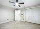 Bedroom with tile floors, ceiling fan, and white louvered closet doors at 2322 Melonie Trl, New Smyrna Beach, FL 32168