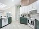 Modern kitchen with green cabinets, white countertops, and tile flooring at 2322 Melonie Trl, New Smyrna Beach, FL 32168