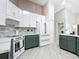 Modern kitchen with green cabinets, white quartz countertops, and a range hood at 2322 Melonie Trl, New Smyrna Beach, FL 32168