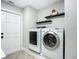 Laundry room with washer, dryer, and built-in shelving at 2322 Melonie Trl, New Smyrna Beach, FL 32168