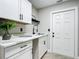 Laundry room with white cabinets, quartz countertop, and sink at 2322 Melonie Trl, New Smyrna Beach, FL 32168